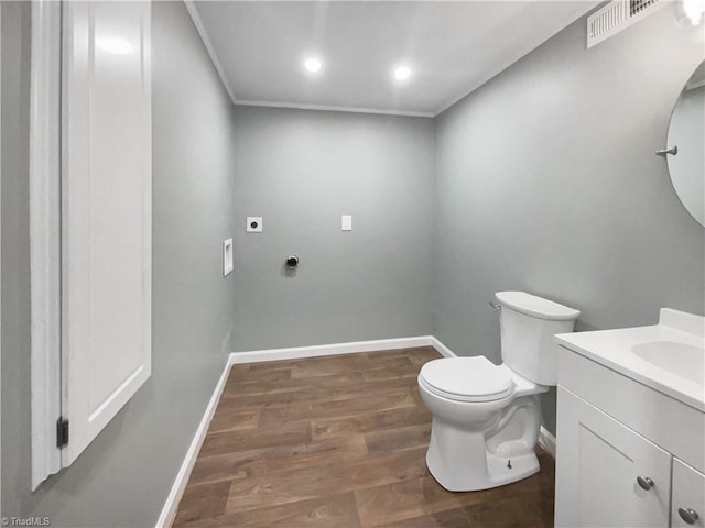 bathroom featuring toilet, hardwood / wood-style flooring, crown molding, and vanity