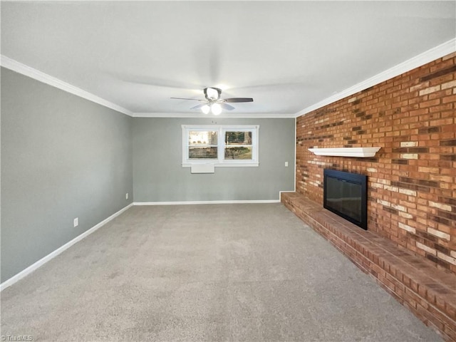 unfurnished living room with ceiling fan, crown molding, a brick fireplace, and carpet