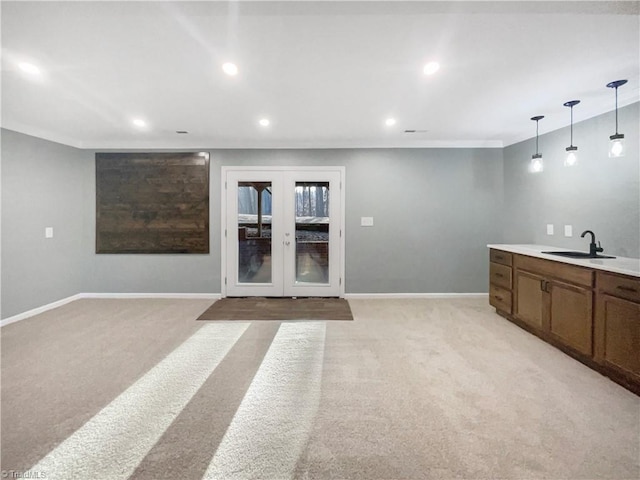 interior space featuring sink, french doors, and ornamental molding