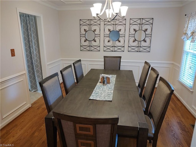 3210 Clamoor Dr, Winston-Salem, NC 27127 - dining area featuring a chandelier, wood finished floors, crown molding, a decorative wall, and wainscoting