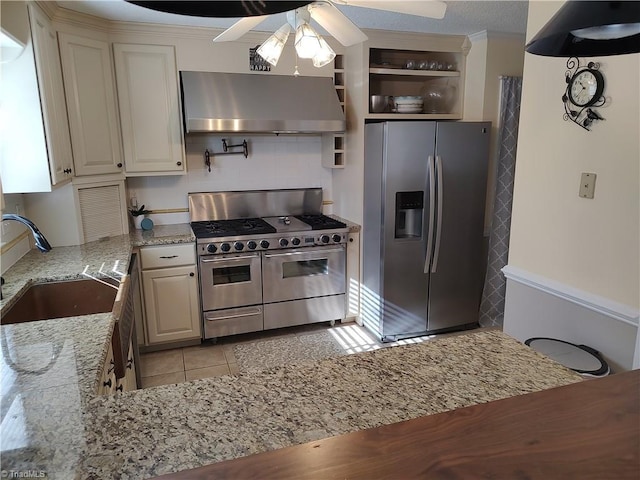 3210 Clamoor Dr, Winston-Salem, NC 27127 - kitchen featuring appliances with stainless steel finishes, wall chimney exhaust hood, ceiling fan, light stone countertops, and light tile patterned flooring