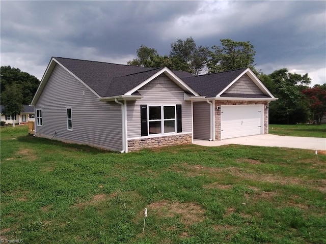 view of front of home with a front yard and a garage