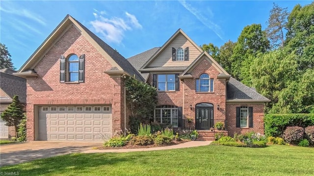 1250 Whitworth Ct, Kernersville, NC 27284 - traditional-style house featuring brick siding, driveway, a front yard, and a garage