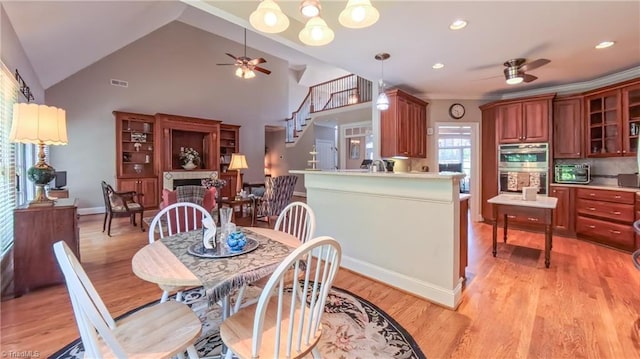 1250 Whitworth Ct, Kernersville, NC 27284 - dining space with ceiling fan, light wood-style floors, a fireplace, high vaulted ceiling, and recessed lighting