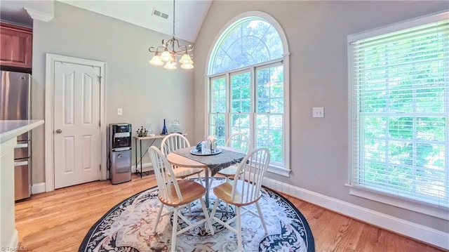 1250 Whitworth Ct, Kernersville, NC 27284 - dining space featuring healthy amount of natural light, light wood finished floors, and a chandelier