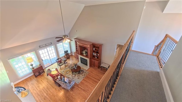 1250 Whitworth Ct, Kernersville, NC 27284 - living room with high vaulted ceiling, healthy amount of natural light, ceiling fan, wood finished floors, and a fireplace with flush hearth
