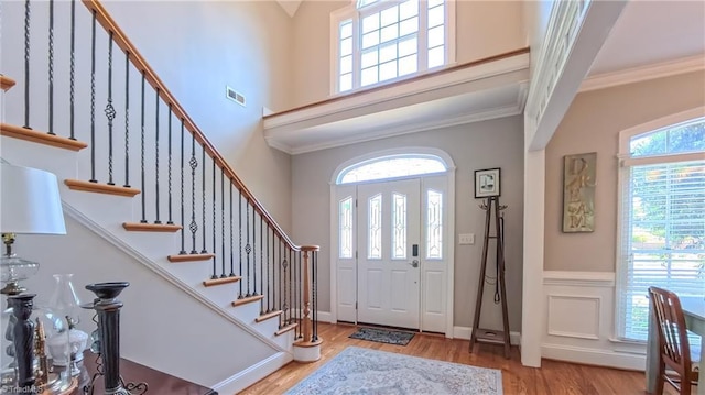 1250 Whitworth Ct, Kernersville, NC 27284 - foyer entrance with a towering ceiling, plenty of natural light, wood finished floors, stairway, and crown molding