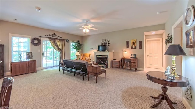 1250 Whitworth Ct, Kernersville, NC 27284 - living area with light carpet, a ceiling fan, and a fireplace