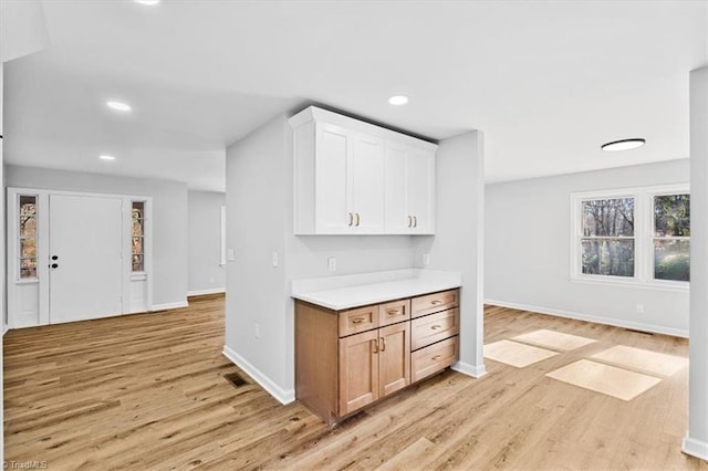 kitchen featuring white cabinets and light wood-type flooring