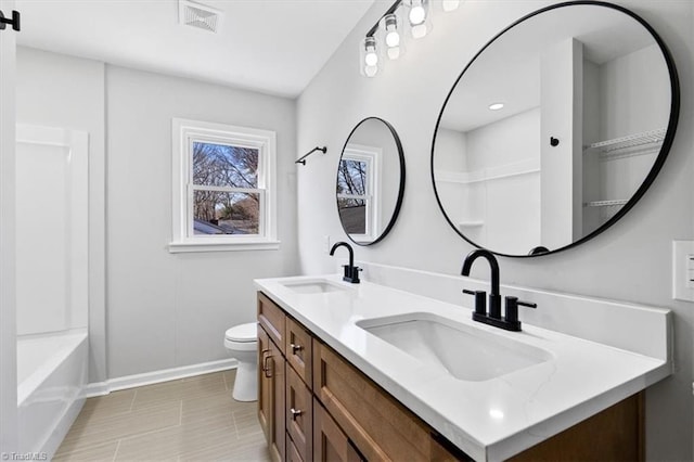 bathroom with vanity and toilet