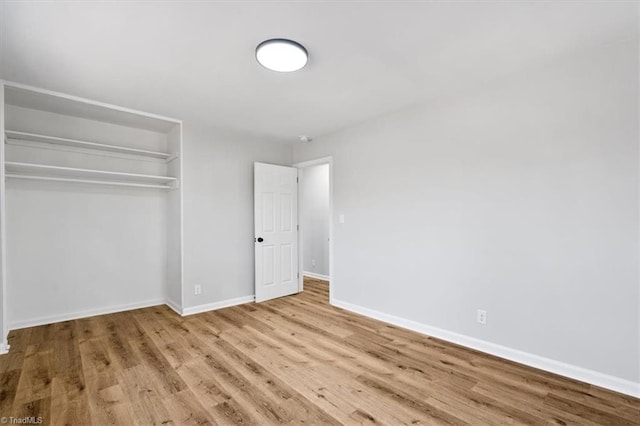 unfurnished bedroom featuring light hardwood / wood-style floors and a closet