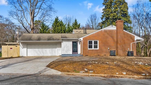 ranch-style home with a garage and central AC