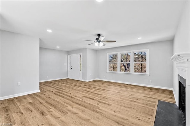 unfurnished living room with ceiling fan and light hardwood / wood-style flooring