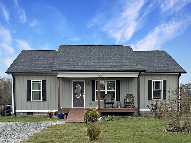 view of front of home with a porch, a front yard, and central air condition unit