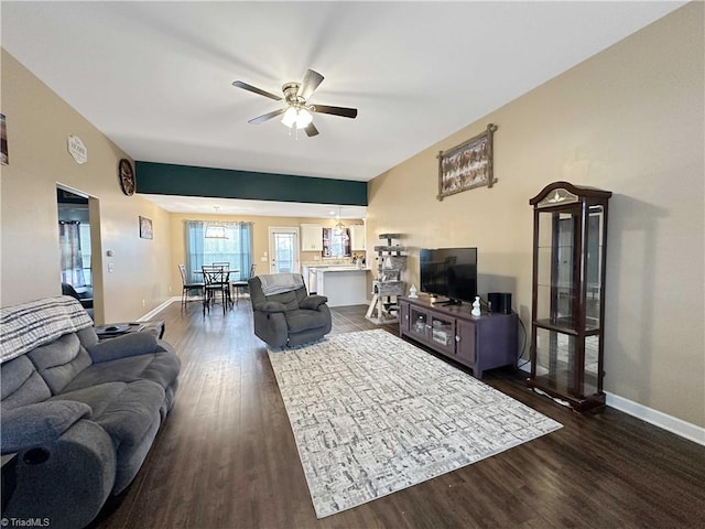 living room with ceiling fan and dark hardwood / wood-style floors