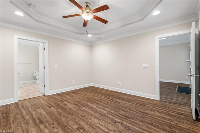 5707 Washburn Ln, Colfax, NC 27235 - empty room with dark wood-style floors, a tray ceiling, ceiling fan, recessed lighting, and ornamental molding