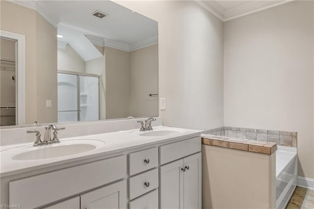 5707 Washburn Ln, Colfax, NC 27235 - bathroom featuring crown molding, double vanity, a shower stall, a bath, and baseboards