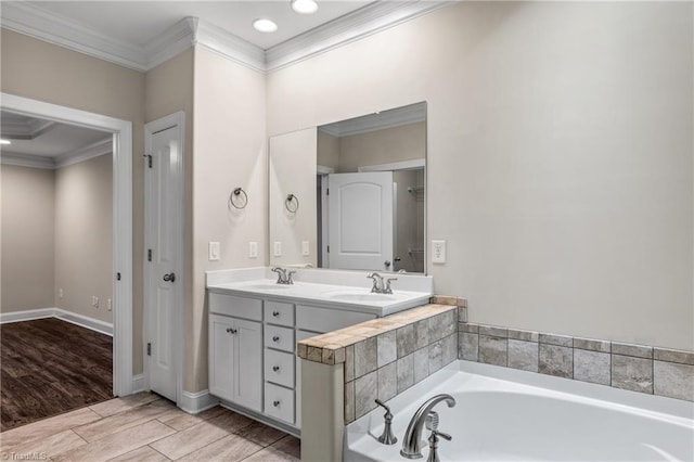 5707 Washburn Ln, Colfax, NC 27235 - bathroom with ornamental molding, a garden tub, double vanity, wood finished floors, and baseboards