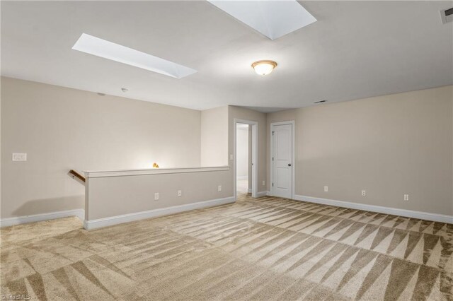 5707 Washburn Ln, Colfax, NC 27235 - carpeted empty room with a skylight and baseboards