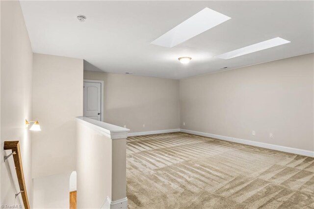 5707 Washburn Ln, Colfax, NC 27235 - empty room featuring carpet, baseboards, a skylight, and a smoke detector