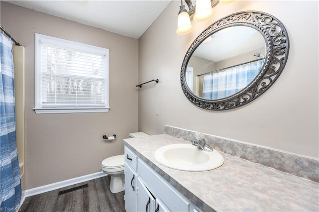 bathroom with hardwood / wood-style floors, toilet, and vanity