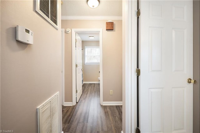 hall featuring dark wood-type flooring and ornamental molding