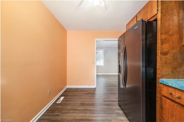 kitchen featuring black fridge with ice dispenser and dark hardwood / wood-style floors