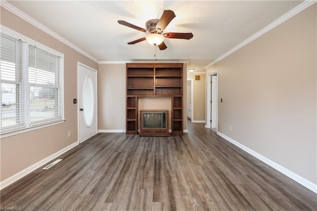 unfurnished living room with crown molding, dark wood-type flooring, and a textured ceiling