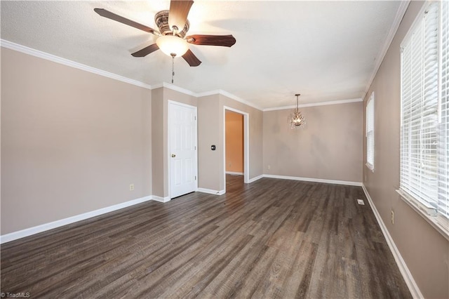 spare room featuring ornamental molding, dark hardwood / wood-style floors, and ceiling fan with notable chandelier