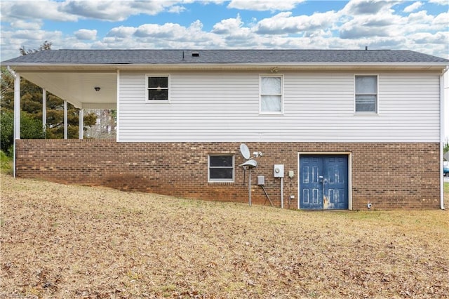 rear view of property with a yard