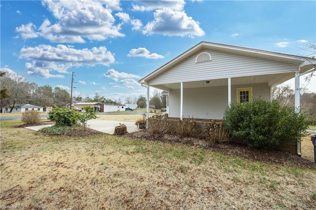 view of side of home featuring a lawn