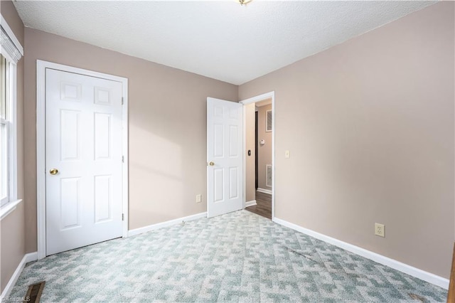 unfurnished bedroom with carpet floors