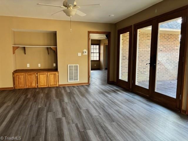 unfurnished living room featuring dark hardwood / wood-style flooring and ceiling fan