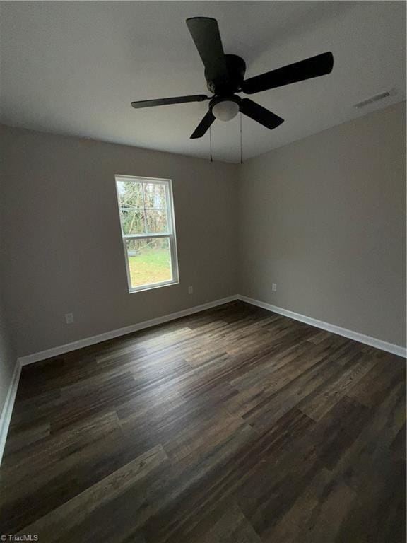 unfurnished room featuring ceiling fan and dark hardwood / wood-style flooring