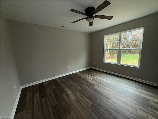 unfurnished room with ceiling fan and dark hardwood / wood-style floors