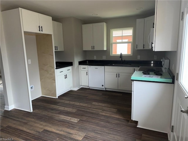 kitchen with sink, white appliances, white cabinets, and dark hardwood / wood-style flooring