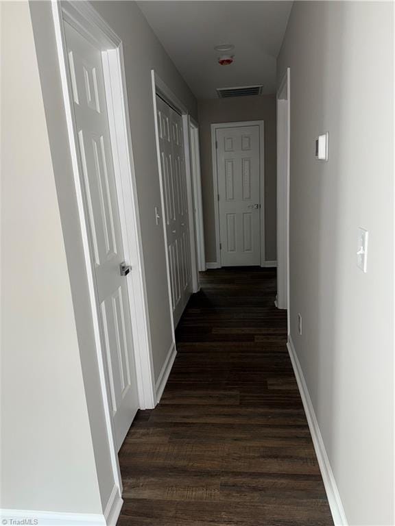 hall with dark hardwood / wood-style floors