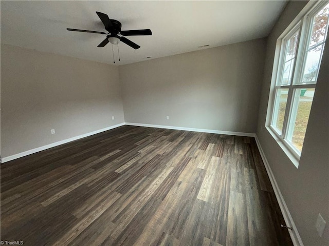 unfurnished room featuring dark wood-type flooring and ceiling fan