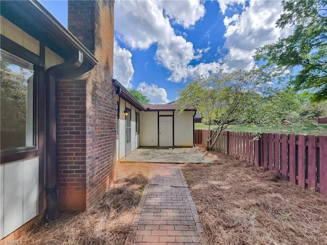 fenced backyard with a patio area