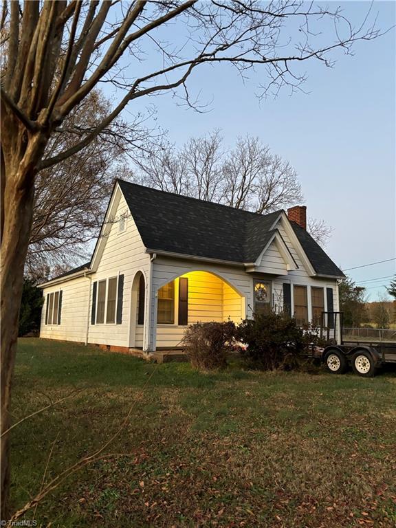 view of property exterior with a yard