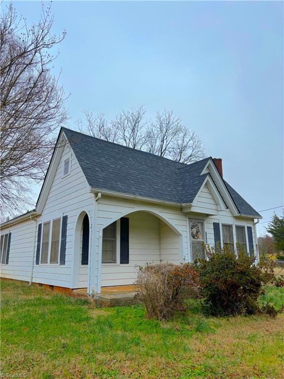 view of side of property with a yard