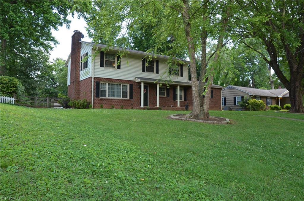1613 Normandy Ln, Winston-Salem, NC 27103 - traditional home with a chimney and brick siding