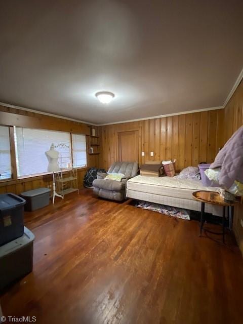 unfurnished bedroom featuring hardwood / wood-style flooring, crown molding, and wood walls