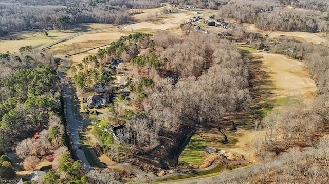 bird's eye view with a wooded view