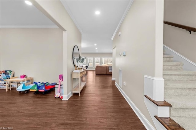 hall with stairs, crown molding, wood finished floors, and baseboards