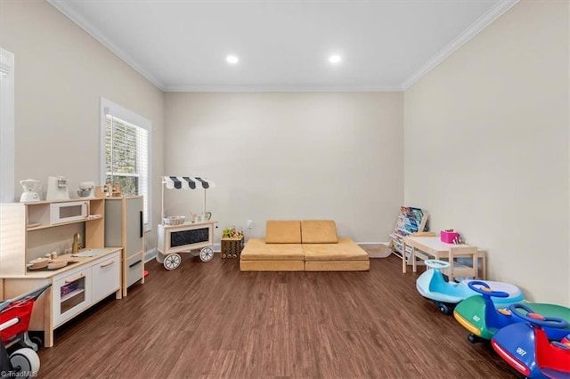 recreation room with recessed lighting, ornamental molding, baseboards, and wood finished floors