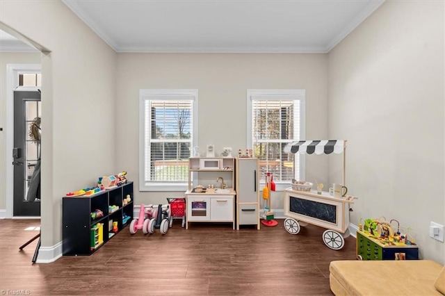 game room with dark wood finished floors, baseboards, arched walkways, and ornamental molding