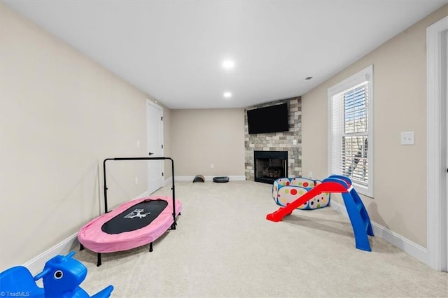 game room featuring recessed lighting, carpet flooring, baseboards, and a fireplace