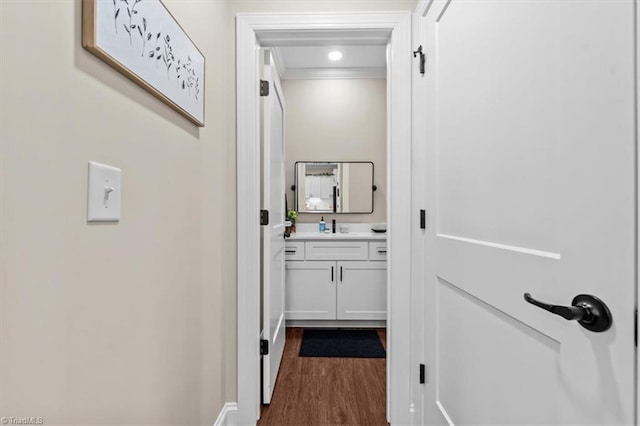 hall with ornamental molding and dark wood finished floors