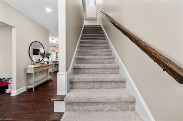 stairway with recessed lighting, baseboards, and wood finished floors